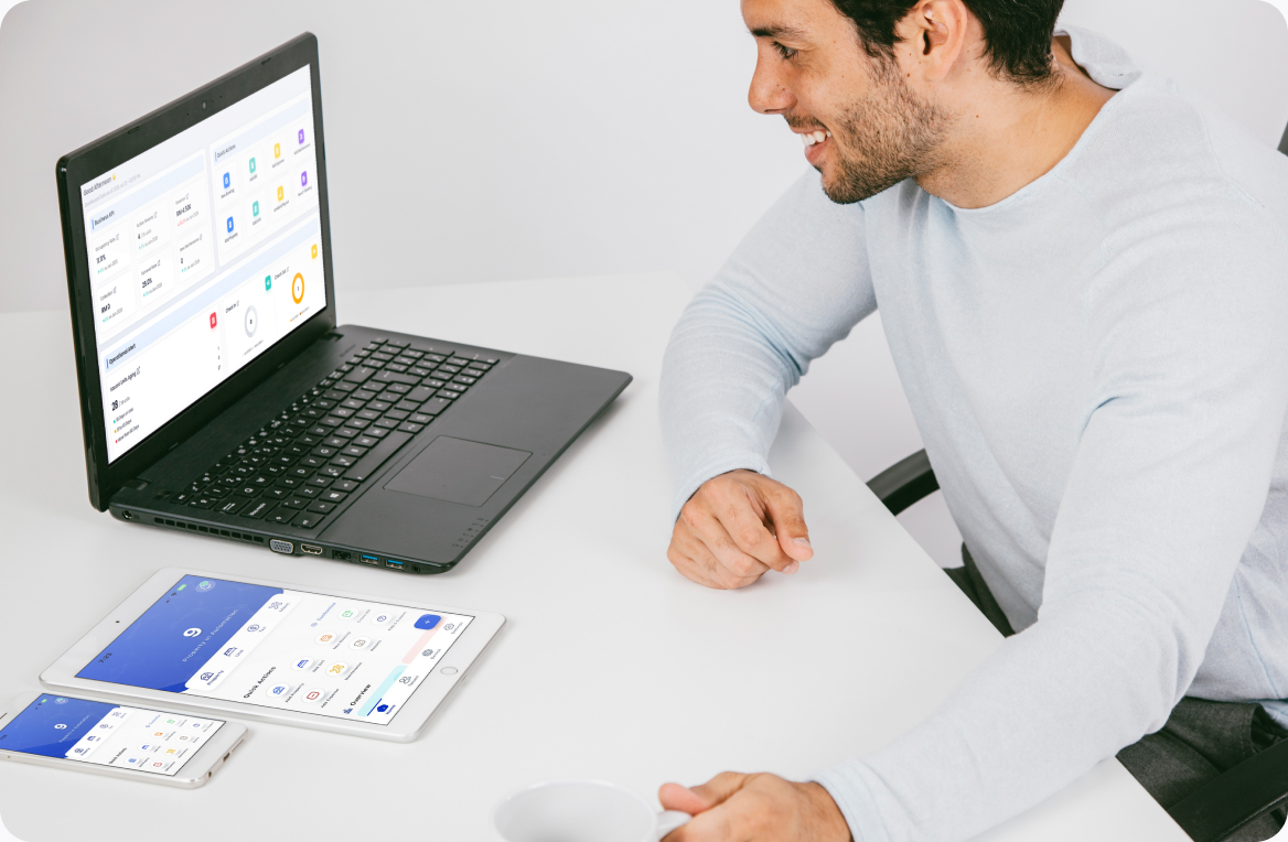 A property operator reviewing the EasyRenz dashboard on a laptop, with the mobile app open beside it.