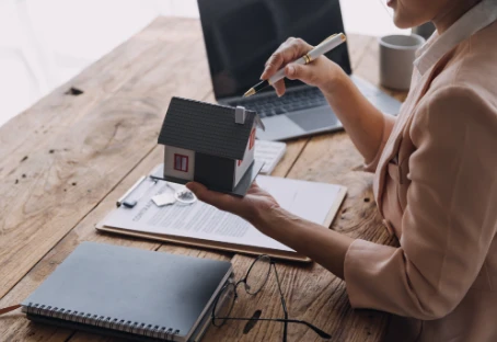 A property manager reviewing rental paperwork on a laptop.
